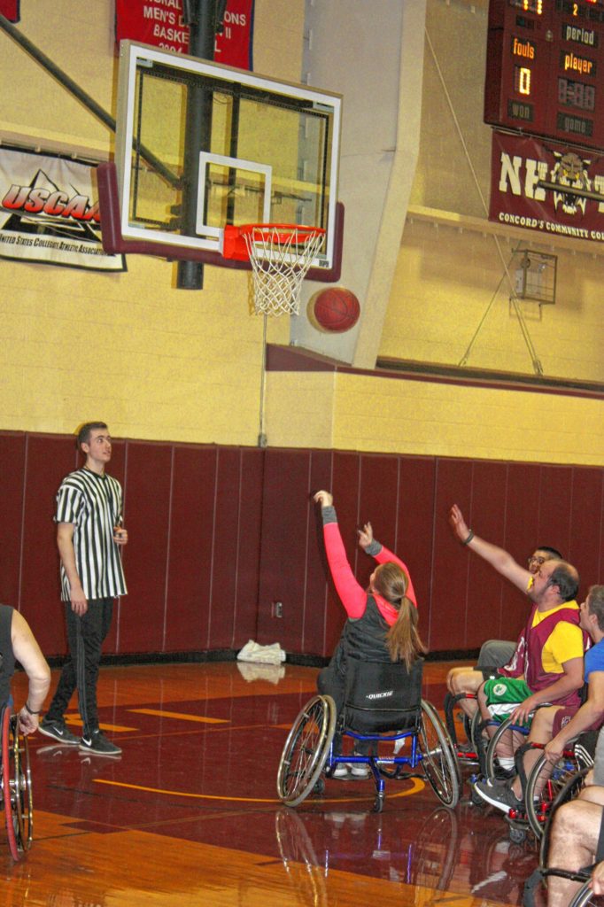 NHTI student Terri Folsom puts up a close-range shot during the Wheelchair Basketball Benefit last week. (JON BODELL / Insider staff)