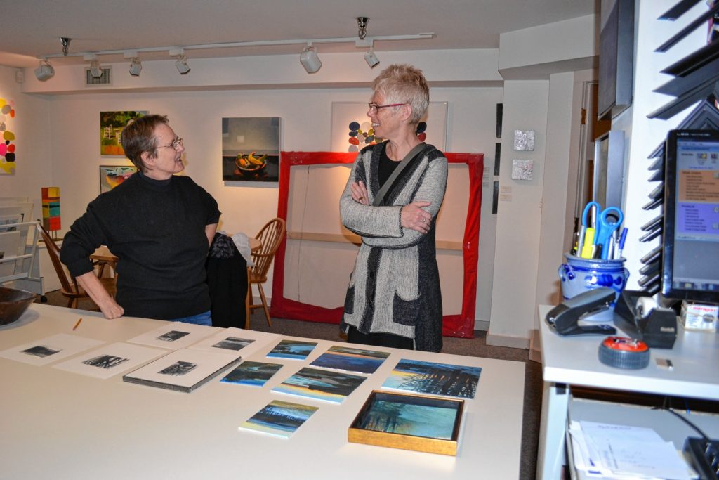 Sarah Chaffee, owner of McGowan Fine Art, talks with one of her many artists, Sandy Wadlington, about some of her new work at the gallery last week.