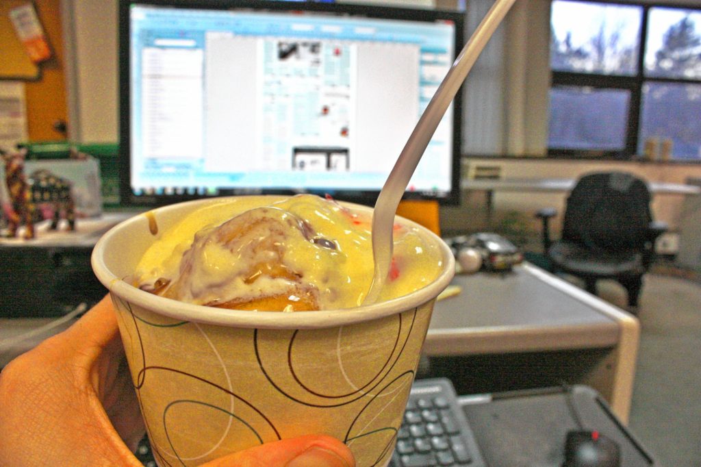 Jon prepares to down his maple ice cream butterscotch sundae from Arnie’s Place while working last Sunday night.