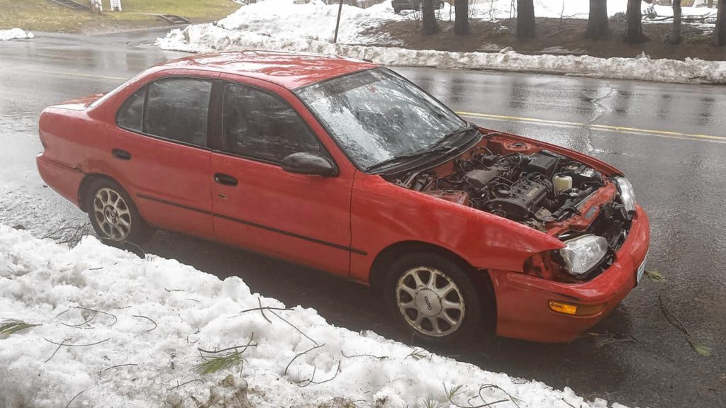 We always thought a hood was an important piece of an automobile – you know, to keep safe all those vital parts that make a car drive. But apparently that’s not the case – at least for this Geo Prizm we saw on a rainy day last week. Maybe you see cars without hoods quite often, but this might be the first one we’ve seen – outside of the movies.