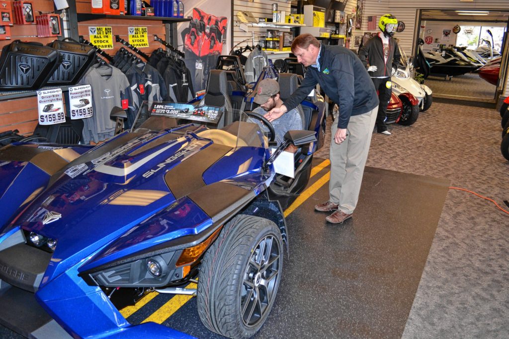 HK Powersports owner Jim Whaley shows Jon a thing or two about the Polaris Slingshot inside the showroom in Hooksett last week.  In a matter of minutes, Jon would be outside in a slightly different model, tearing up the pavement like there's no tomorrow.(TIM GOODWIN / Insider staff)