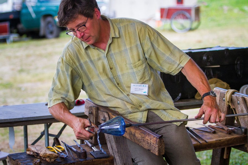 Harry Besett gives a handblown glass demonstration during the League of New Hampshire Craftsmen Fair at Mount Sunapee Resort in Newbury on Tuesday, Aug. 4, 2015. The annual fair runs through August 9.  (ELIZABETH FRANTZ / Monitor staff) ELIZABETH FRANTZ
