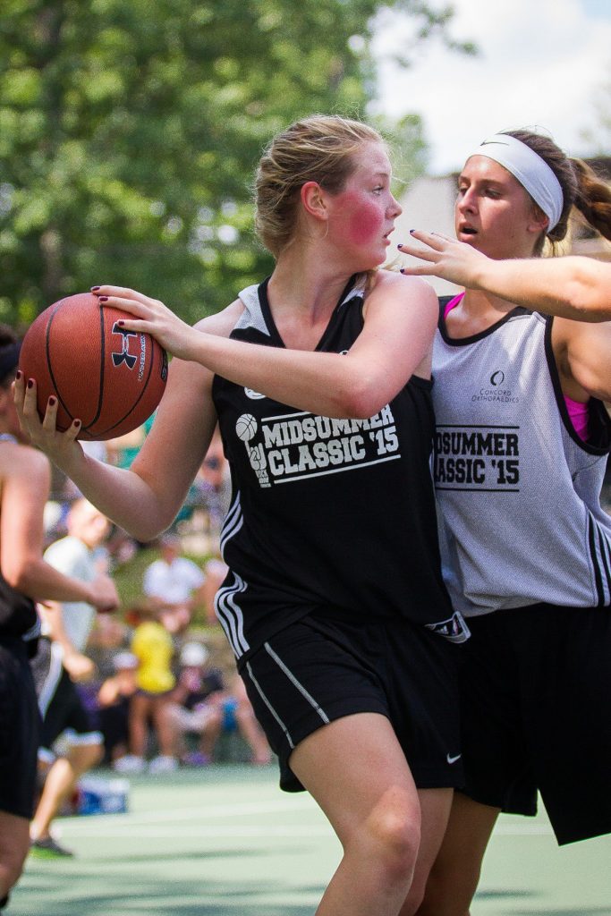 Pembroke's Maddy Allen (left) looks for a passing opportunity while Merrimack Valley's Morgan Burr applies pressure during the Midsummer Hoops Classic basketball tournament at Rock on Fest at White Park in Concord on Saturday, Aug. 15, 2015.  (ELIZABETH FRANTZ / Monitor staff) ELIZABETH FRANTZ