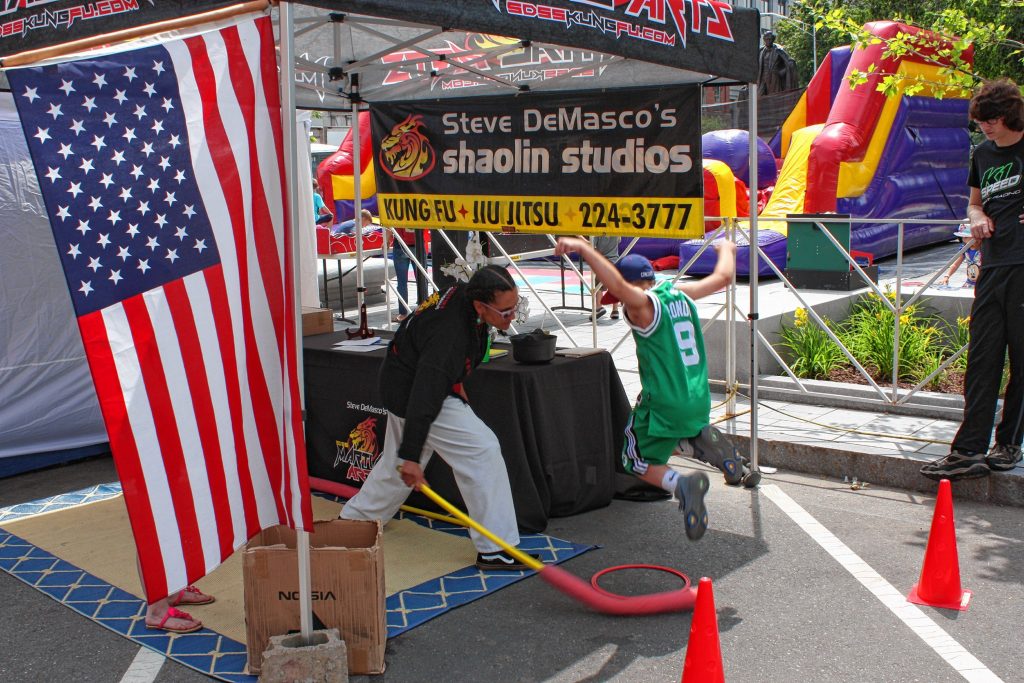 Brody Rossetti, 8, jumps over a foam sword-type thing at the Steve DeMasco's Shaolin Studios martial arts tent at Market Days. JON BODELL / Insider staff