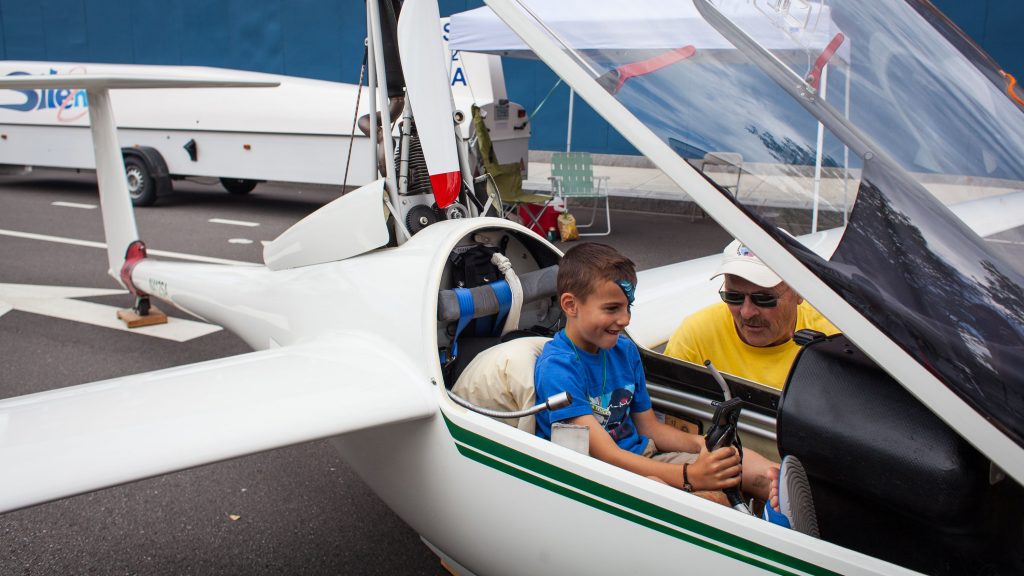 Brody Ricci (left), 7, gets a flying lesson from Steve Arndt from the cockpit of the Silent 2, a self-launching racing sail plane, during the Market Days Festival in downtown Concord on Thursday, June 23, 2016. (ELIZABETH FRANTZ / Monitor staff) 