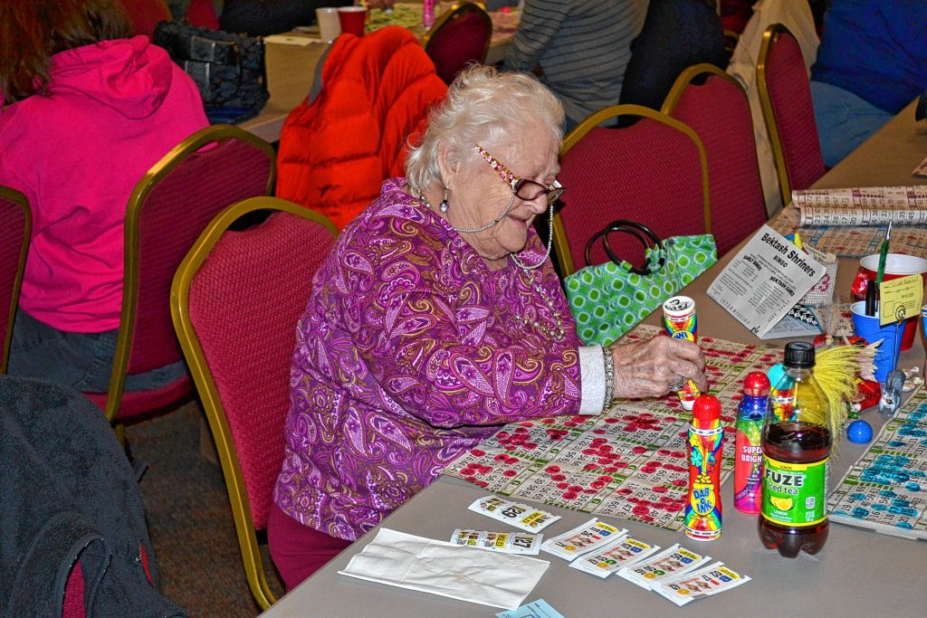Above: Polly Croteau enjoys the early bird games at last Thursday’s weekly bingo get together. Bottom right: Take a gander at all those pull tab tickets. Just think of all the money you could win. Bottom left: A fresh sheet of 18 cards. Top left: Look at all those balls for one little game of carryover coverall.    