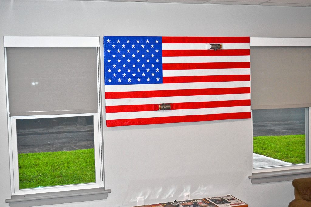 Bow Firefighter/Paramedic Brandon Skoglund made an American flag out of old firehose that is now displayed in the kitchen of the new Bow Safety Center. TIM GOODWIN / Insider staff