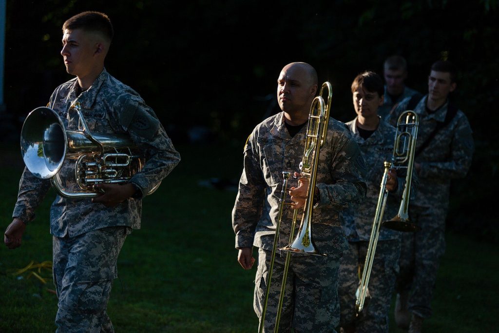 From left, Sgt. Chaz Brinkerhoff, Sfc. Kevin Sawler, Sfc. Tara Fazekas and other members of the New Hampshire Army National Guard 39th Army Band walk to their positions at the start of a summer concert on the lawn of the Pierce Manse in Concord on July 24, 2014. The Pierce Manse was celebrating 40 years of being open to the public.  (WILL PARSON/Monitor staff) Will Parson