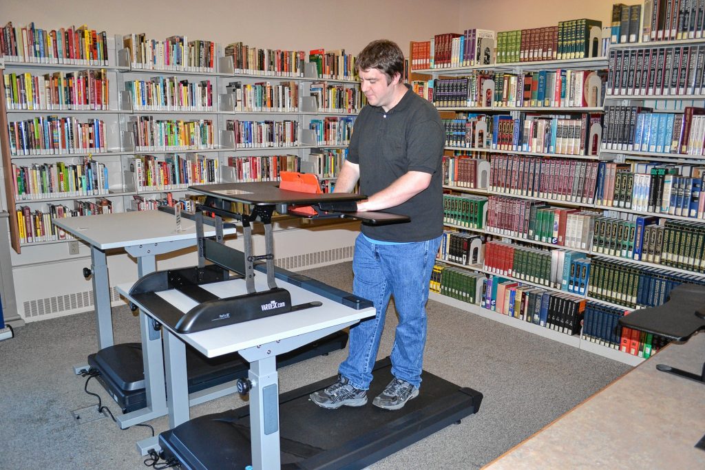 NHTI student Derek White takes the new treadmill desks for a spin last week.  TIM GOODWIN / Insider staff