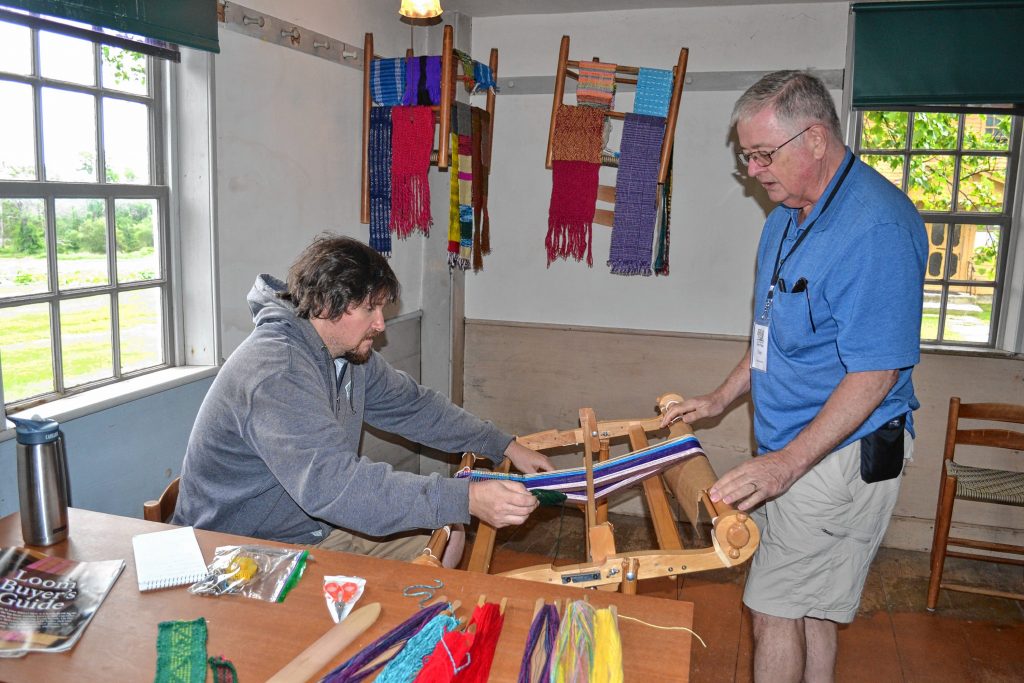 Tim tries his hand at weaving at the Canterbury Shaker Village.  Becky Soules / For the Insider