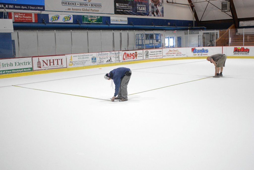 Brent Beyor (wearing hat) and Mike South (in shorts and a T-shirt) had their work cut out for them at Everett Arena last Thursday. One of the true signs of the end of summer is when the arena transitions from an event space back to a hockey rink, and there's a lot of work that goes into it. We watched as the guys sprayed water, ran yarn from one side of the rink to the other, took lots of measurements, traced some shapes and painted the ice to get it ready for skating, which began Monday. JON BODELL / Insider staff