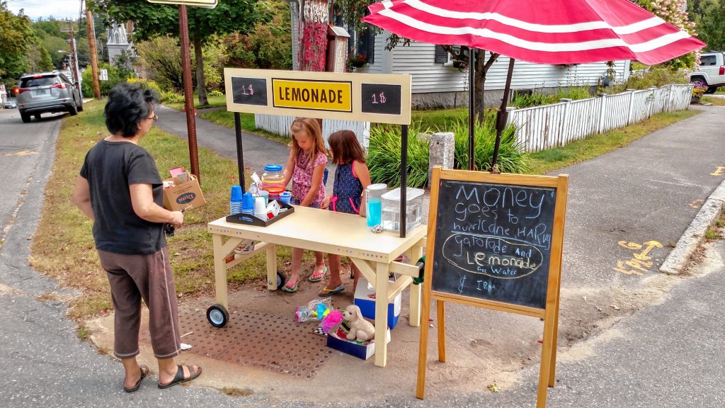 Christa McAuliffe School students Emma (left) and Sadie Pelletier run a lemonade stand near their house on Sept. 10. All of the money made from the sales of lemonade and Gatorade went to help relief efforts in Florida and Houston, after hurricanes Harvey and Irma wreaked havoc in those areas. Courtesy