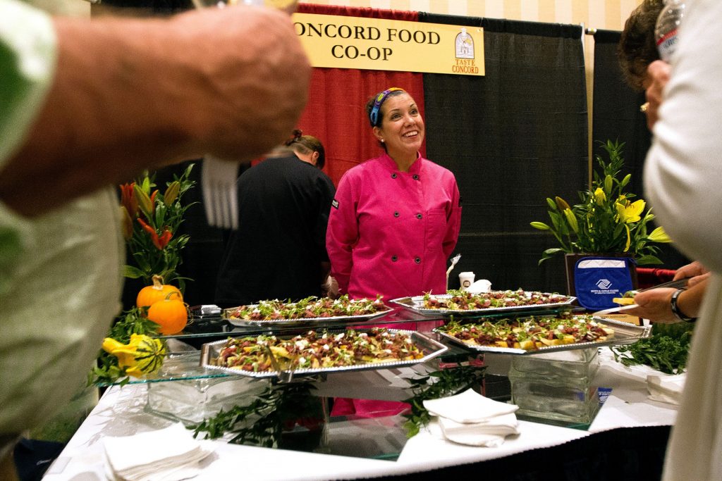 Tracy Fitts, a sous shef at the Concord Co-op, talks to visitors at the ninth annual Taste of Concord at the Grappone Conference Center on Thursday, Oct. 9, 2014. The Co-op offered their version of steak tartare.  (JULIE BYRD-JENKINS / Monitor staff) JULIE BYRD-JENKINS