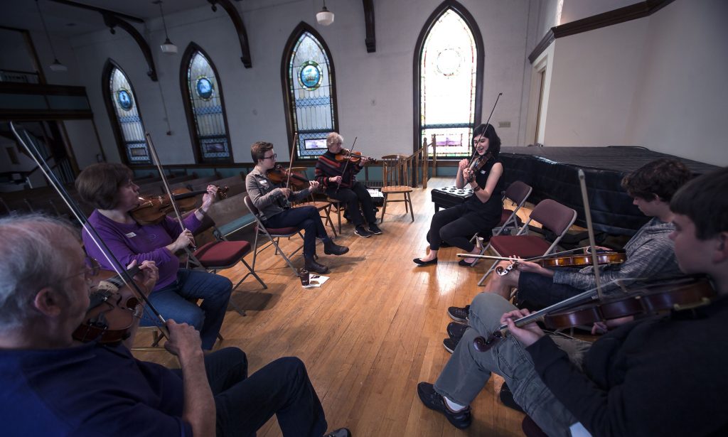 Elizabeth Faiella, upper right, teaches Irish tunes and techniques in the recital hall at the Concord Community Music School Saturday. GEOFF FORESTER