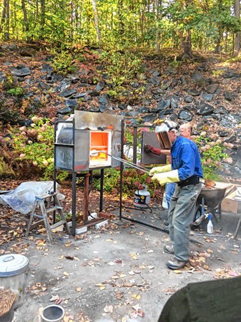 Andy Hampton tends to his outdoor kiln. Courtesy