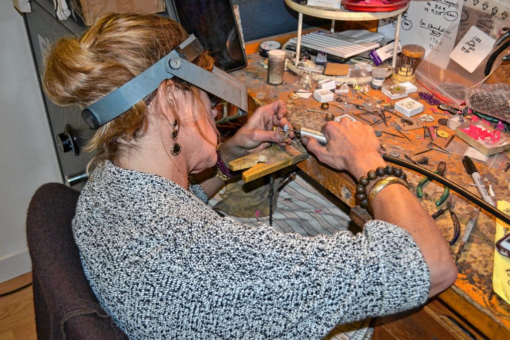 Kristin Kennedy works on a piece of jewelry in her downtown Concord studio. TIM GOODWIN / Insider staff