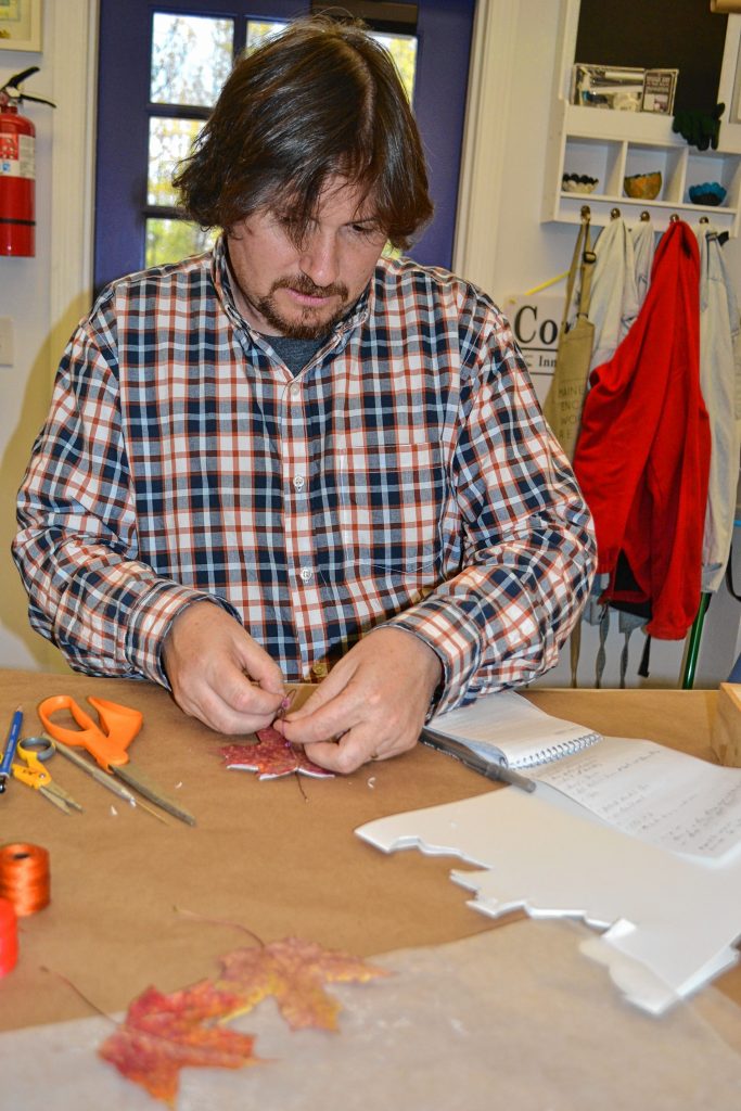 Tim makes a leaf book at Twiggs Gallery, a craft that you can try during a visit to the Boscawen art hotspot. ADELE SANBORN / For the Insider