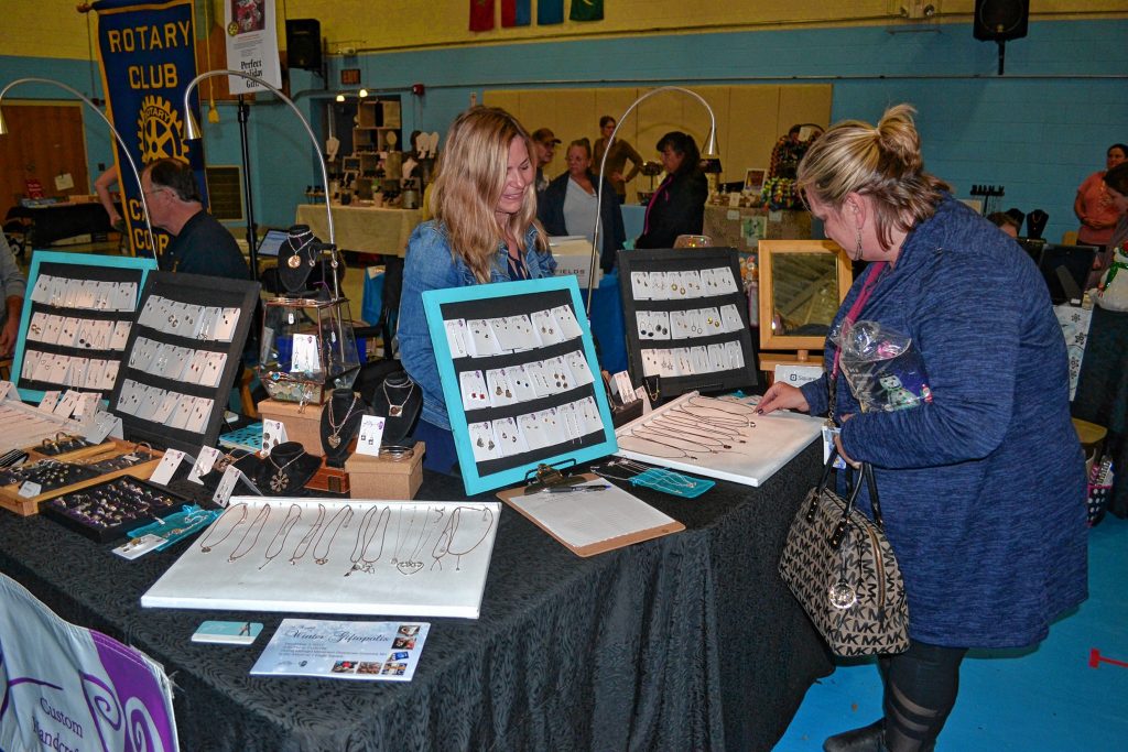 Kitty Stoykovich talks with Deborah Snow-Major about her jewelry at the One Stop Shop Extravaganza last week. TIM GOODWIN / Insider staff