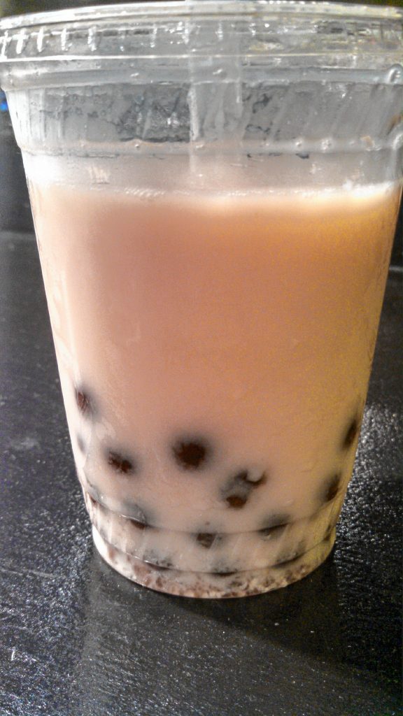 A cup of lychee bubble tea with boba pearls from Noodles & Pearls. THE FOOD SNOB / Insider staff