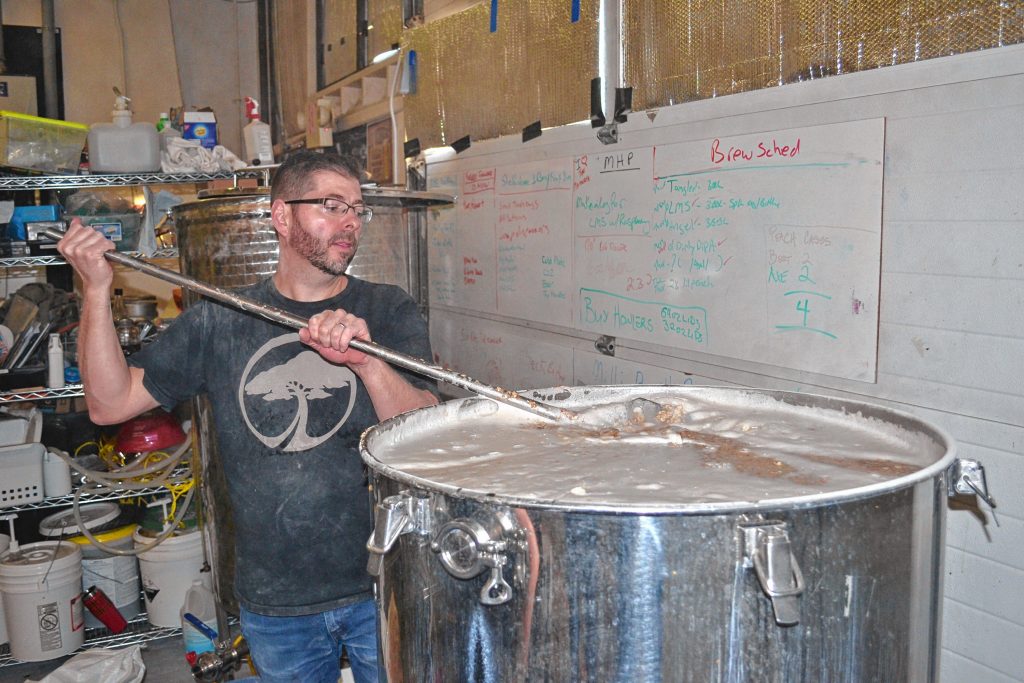 Lithermans Limited co-owner and head brewers Steve Bradbury gets the grains, malts and water all mixed together during a brew day last week. TIM GOODWIN / Insider staff
