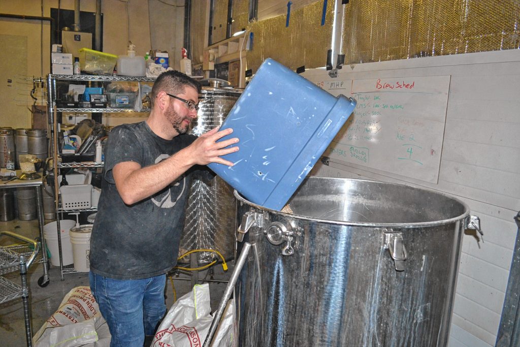 Lithermans co-owner and head brewer Steve Bradbury adds ingredients to a batch of Misguided Angel. TIM GOODWIN / Insider staff