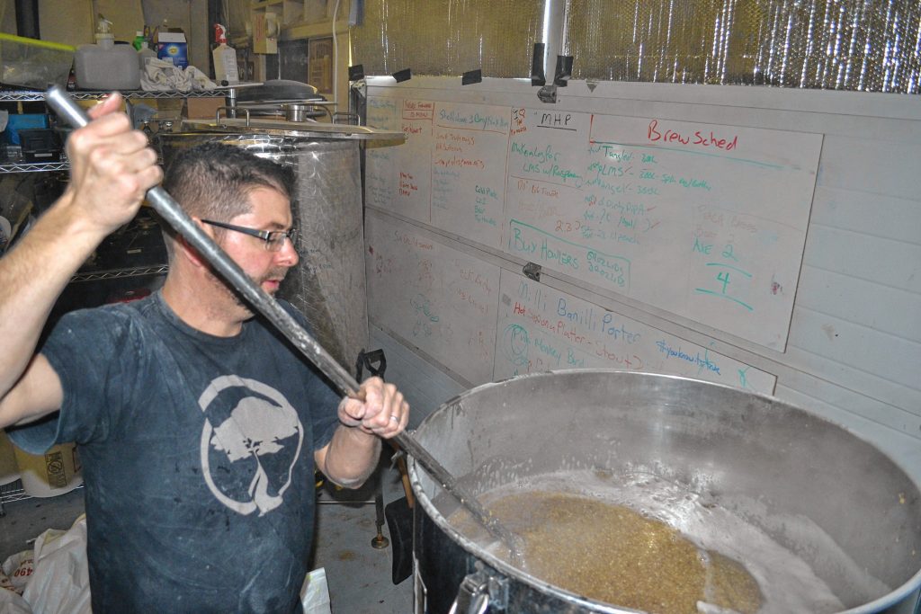 Lithermans Limited co-owner and head brewers Steve Bradbury gets the grains, malts and water all mixed together during a brew day last week. TIM GOODWIN / Insider staff