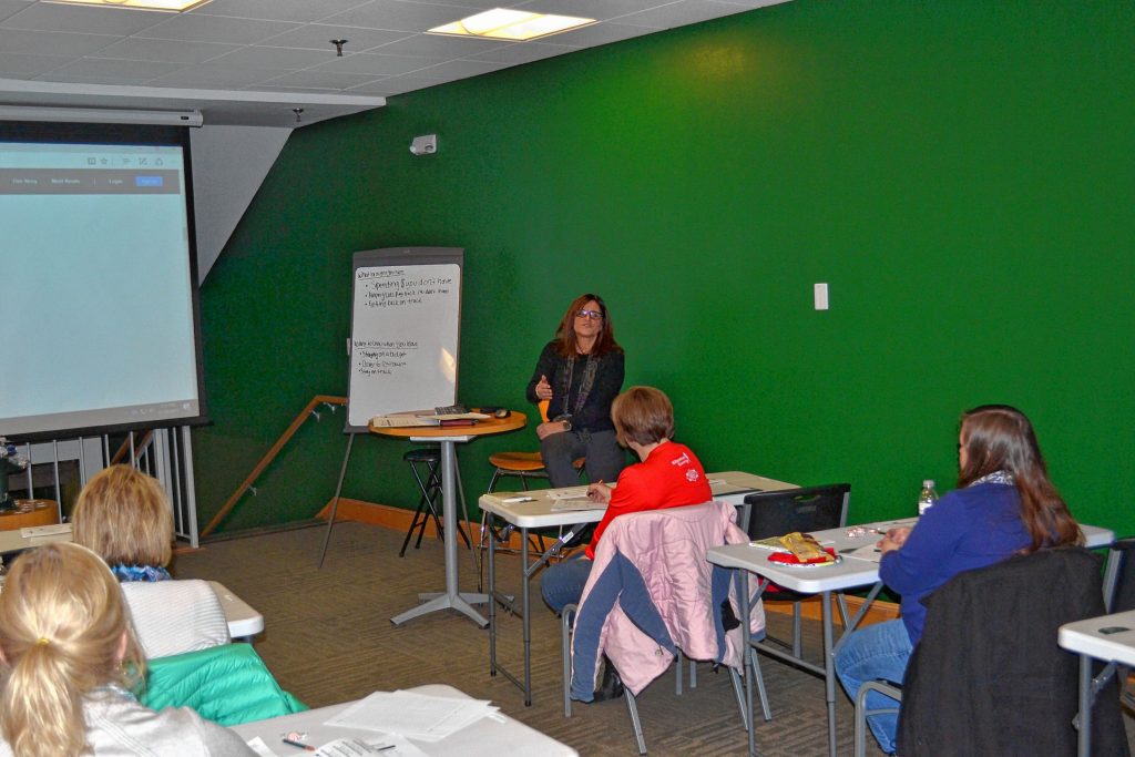 Polly Saltmarsh, vice president of financial education and business development at N.H. Federal Credit Union, talks to a group of community members during Build Your Savings & Spending Plan class. TIM GOODWIN / Insider staff