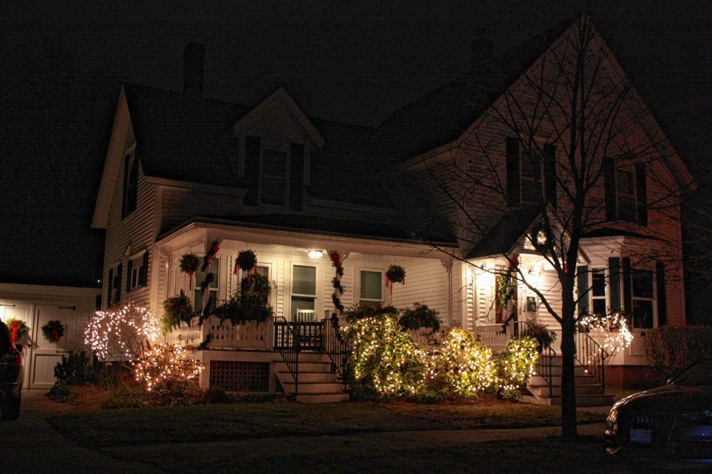 This house on Pillsbury Street achieves a rustic feel with the combination of soft white lights and loads of garland, wreaths and kissing balls.  JON BODELL / Insider staff