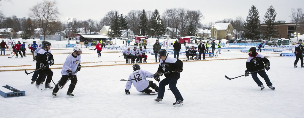 Teams compete at the Black Ice Pond Hockey Tournament at White Park in Concord Saturday. GEOFF FORESTER