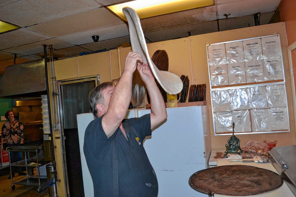 Even when making the 28-inch super dominator, Donatello's owner Bob Boisvert still tosses the dough in the air. TIM GOODWIN / Insider staff