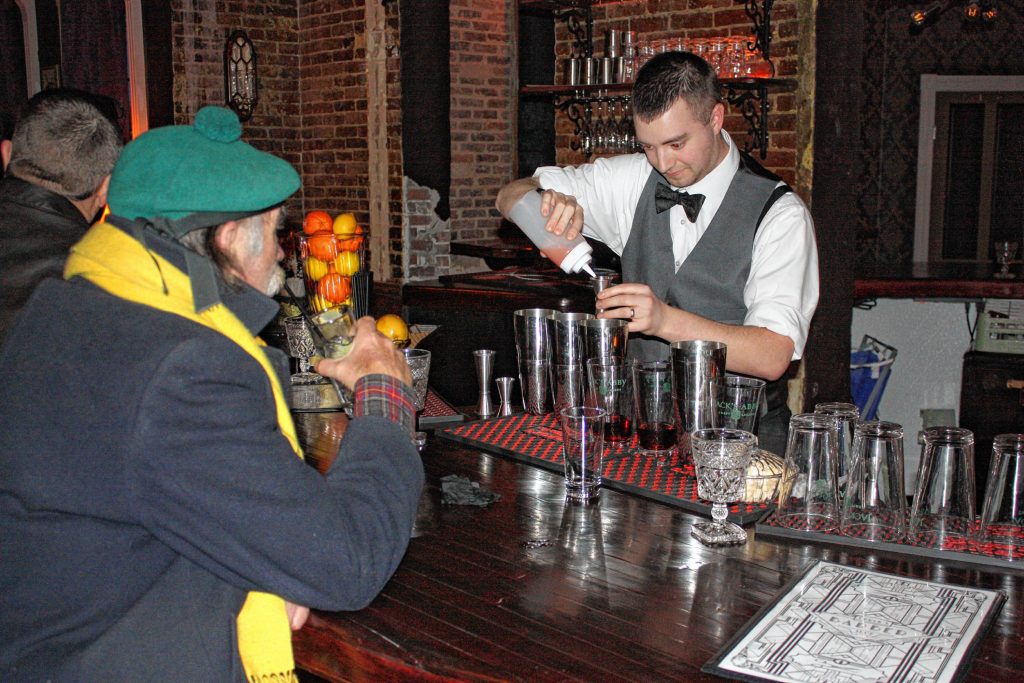 Bartender James Murray prepares a cocktail on opening night of Chuck's Barbershop in Eagle Square last Tuesday. JON BODELL / Insider staff