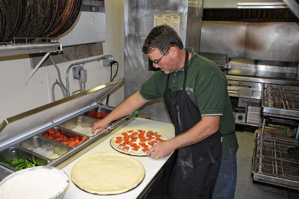 Constantly Pizza co-owner Dave Constant whips up a pepperoni pizza at the downtown location last week. Constant has been making pizza for so long now he can spin a dough on his finger like a Harlem Globetrotter does with a basketball. JON BODELL / Insider staff
