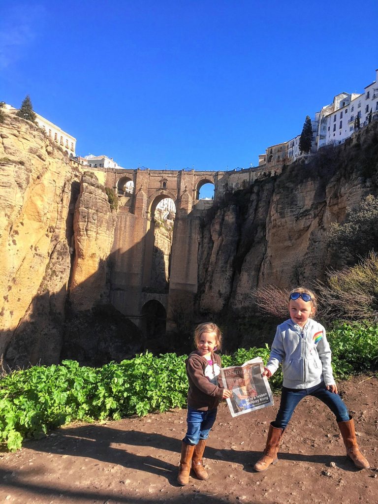 Adeline, 3, and Ella, 5, Lundquist stand in front of Puente Nuevo, a bridge that span the 390 foot chasm that carries the Guadalevín River that divides the city of Ronda, in southern Spain. Courtesy