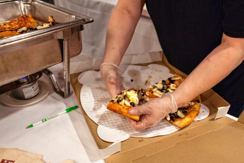 Veano's Italian Kitchen serves slices of Greek pizza during the Pizza Pie Showdown at the Holiday Inn in downtown Concord on Pi Day, Mar. 14, 2018. Proceeds from the event, hosted by the Concord Monitor and Insider, went to support the Friendly Kitchen. (ELIZABETH FRANTZ / Monitor staff) Elizabeth Frantz