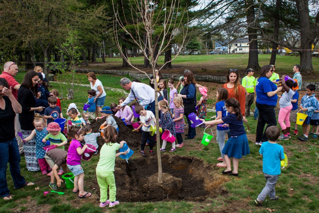 Community children help plant a sugar maple with donated toy buckets and shovels during an Arbor Day celebration at Rollins Park in Concord on Friday, April 28, 2017. (ELIZABETH FRANTZ / Monitor staff) Elizabeth Frantz