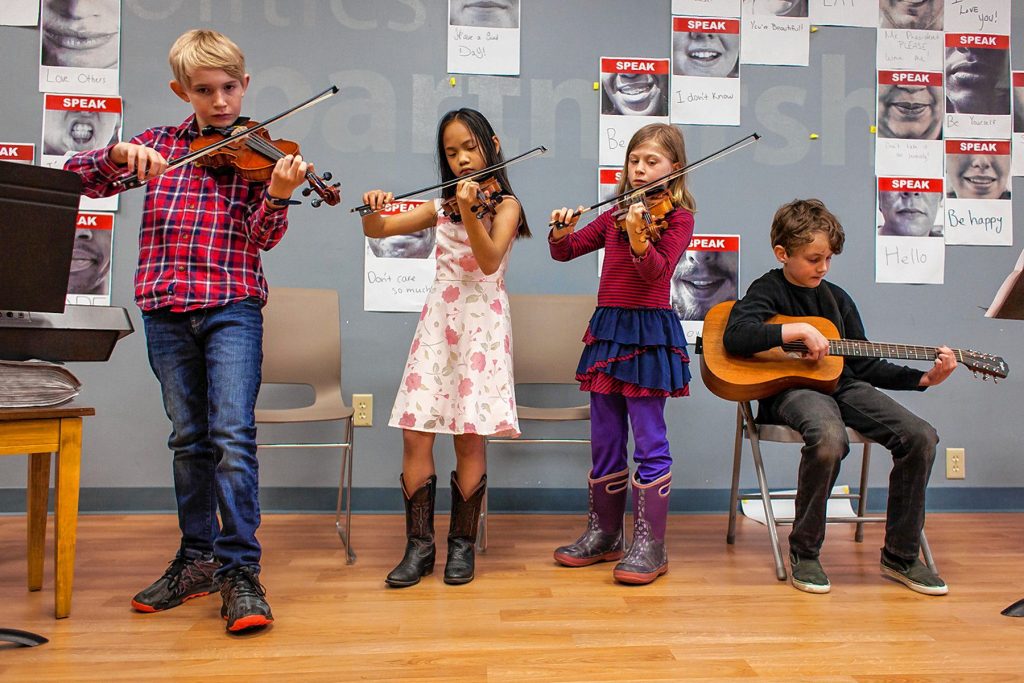 The instrument petting zoo, one of the most popular elements of Concord Community Music School's annual Performathon, allows kids and adults alike to try all kinds of string, wood, brass and percussion instruments. Courtesy of Concord Community Music School