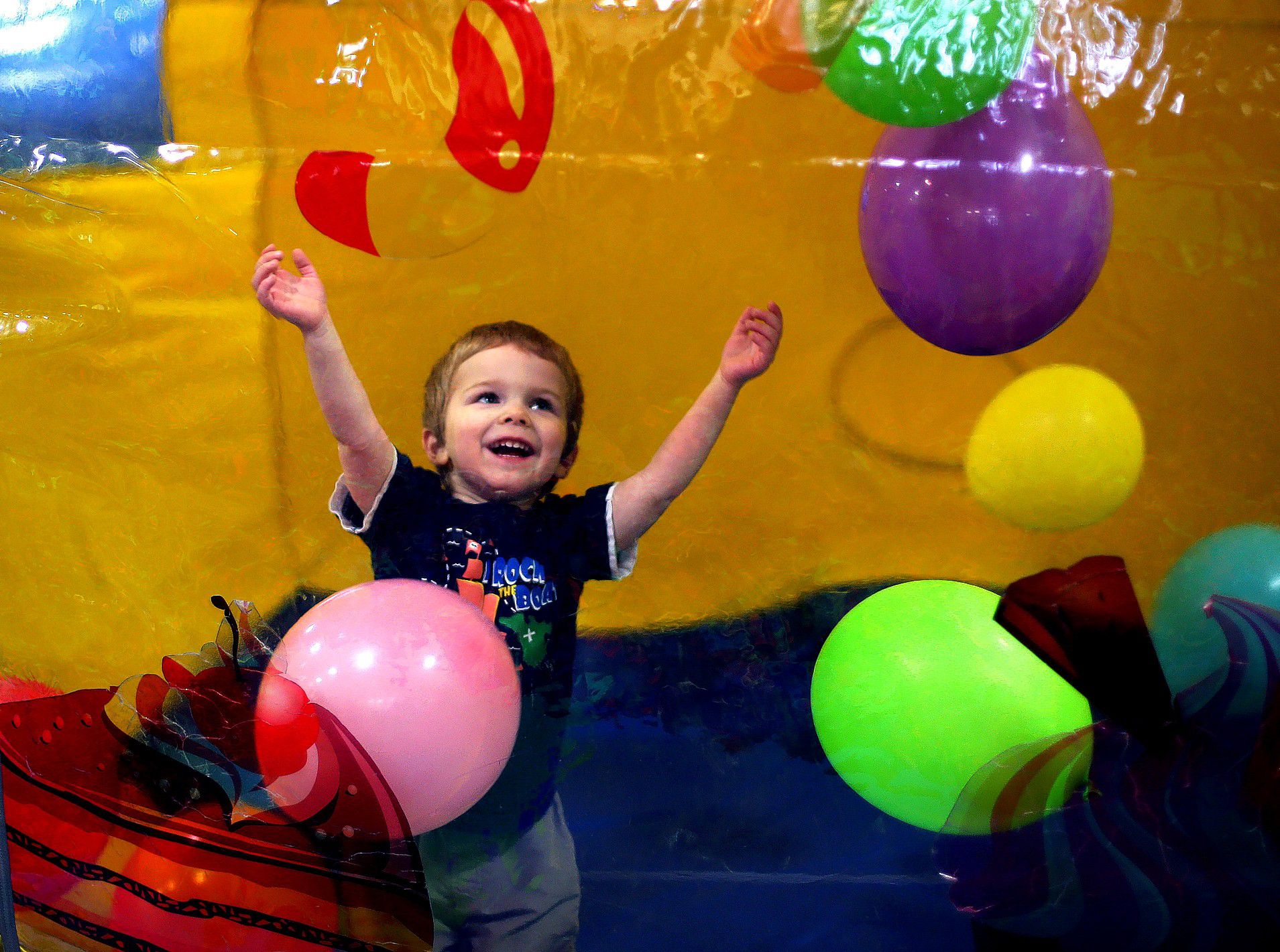 Zeke Harmon, 3, plays with balloons inside a bouncy house at the Krazy Kids indoor play center in Concord  with his family Monday. (GEOFF FORESTER / Monitor staff) 