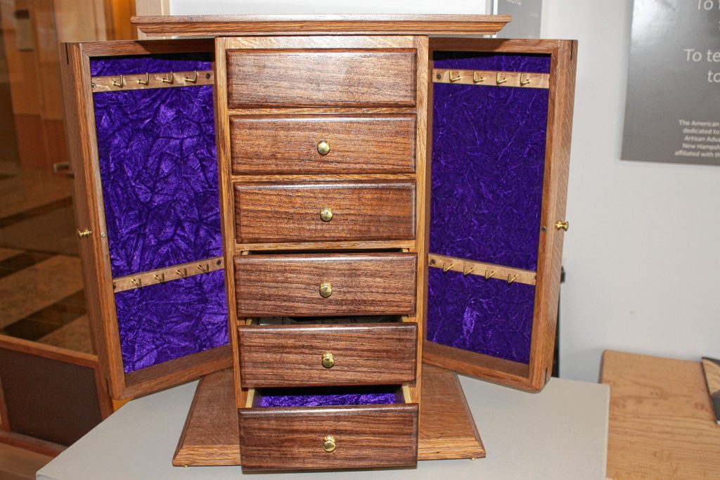 This jewelry cabinet was made by New Hampshire inmate Jeremy Jennings. The piece is part of an exhibit at the New Hampshire Furniture Masters called On the Street, which features furniture made by inmates in New Hampshire and Maine.  JON BODELL / Insider staff
