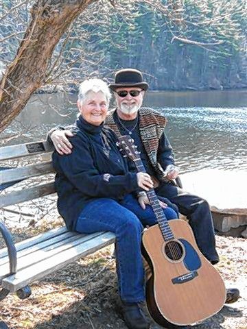 Mike and Bevery Rogers, pictured here on a bench with a guitar, will teach an introduction to harmonica class at Concord Public Library next Wednesday, Aug. 22. The class will be geared toward harmonica enthusiasts ages 8 and up, including adults of all ages. Courtesy of Concord Public Library