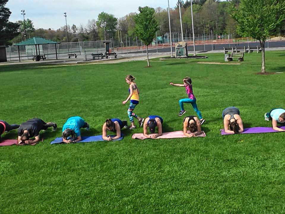 Adults and kids alike participate in Fit 4 a Cause's outdoor bootcamp at Memorial Field.  Courtesy of Renee Plodzik