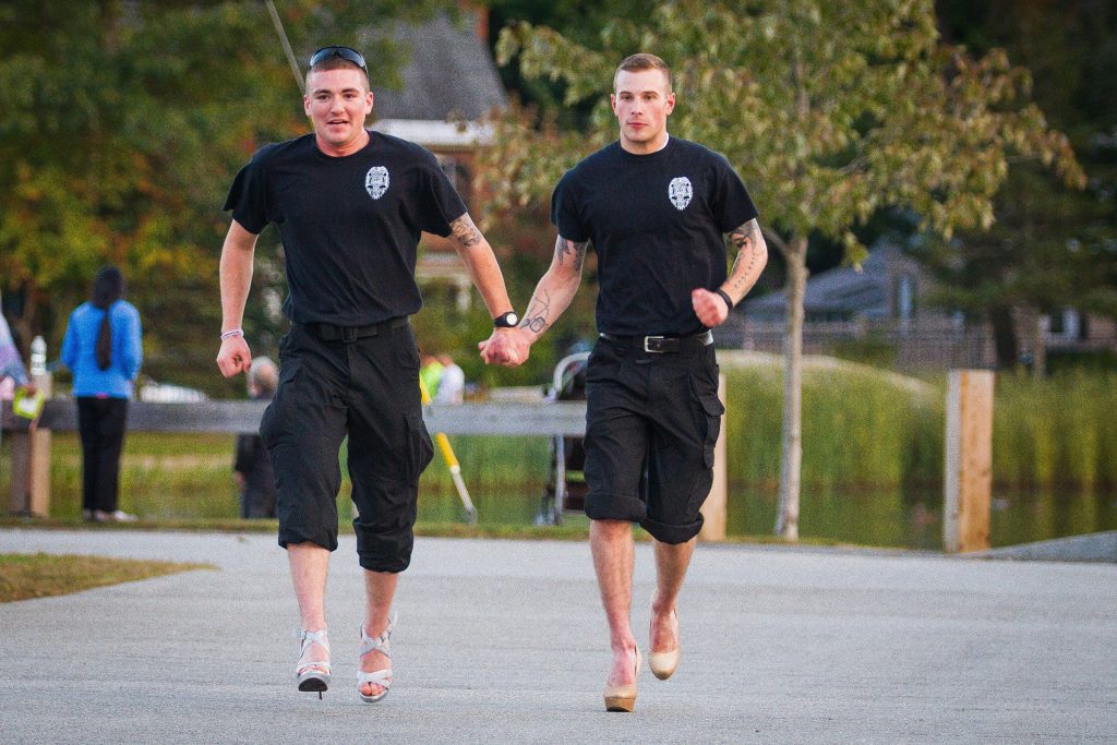 Lucas Collins and Chazz Freeman of Merrimack County Department of Corrections run together to the finish line during the second annual Walk a Mile in Her Shoes event at White Park in Concord on Wednesday, Oct. 7, 2015.  (ELIZABETH FRANTZ / Monitor staff) ELIZABETH FRANTZ
