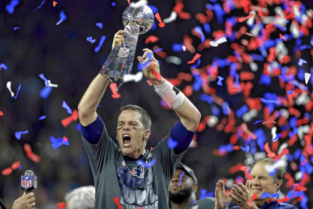 FILE - In this Feb. 5, 2017, file photo, New England Patriots' Tom Brady raises the Vince Lombardi Trophy after defeating the Atlanta Falcons in overtime at the NFL Super Bowl 51 football game, in Houston.  New England wins the Super Bowl. From 25 points in the hole. Brady soars, the cheers grow louder, Falcons turn into clam chowder. (AP Photo/Darron Cummings, File) Darron Cummings