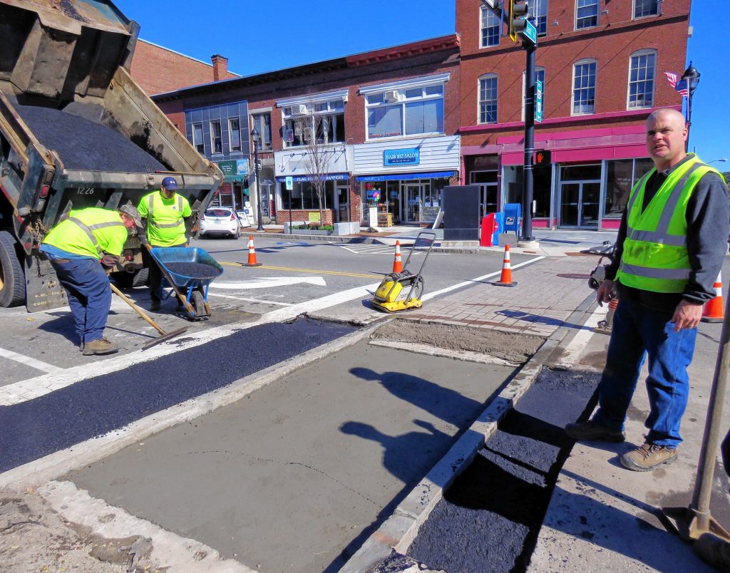 Concord general services workers patch a N. Main and Pleasant Street crosswalk on October 16, 2018. The crosswalk is one of four that needs to be repaired due to drainage issues. Caitlin Andrews