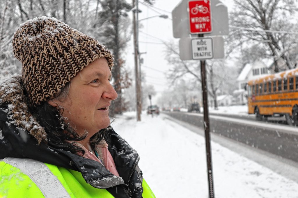 Rose Baker watches cars pass in front of Rundlett Middle School on Tuesday. 