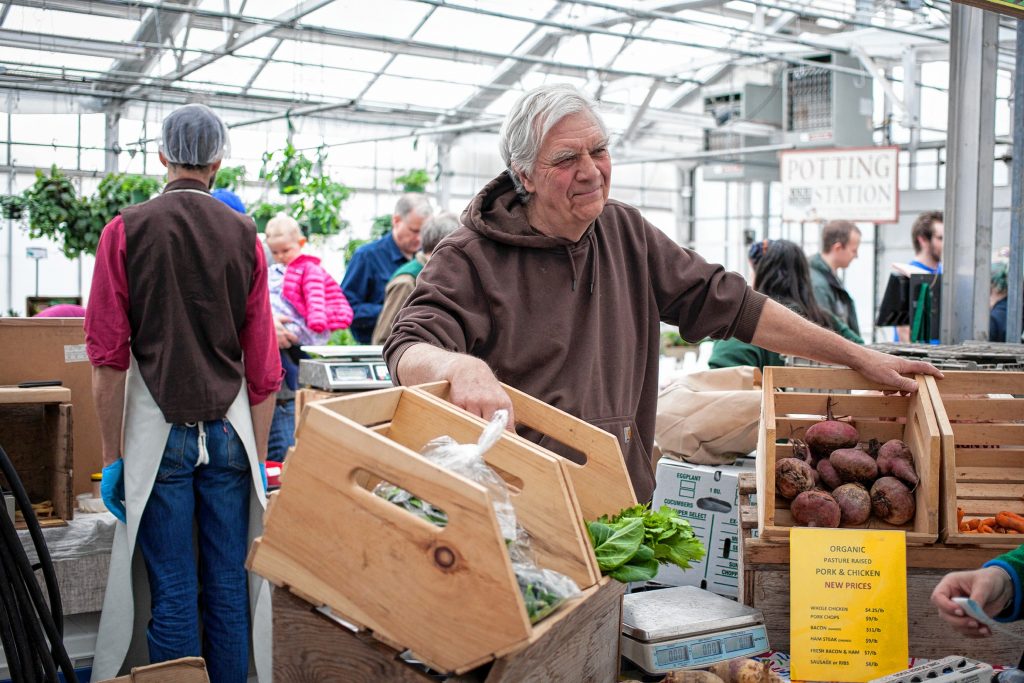 Larry Pletcher of Vegetable Ranch talks to customers at Concordâs Winter Farmers Market at Cole Gardens, April 2, 2016. (ELIZABETH FRANTZ / Monitor staff) Elizabeth Frantz