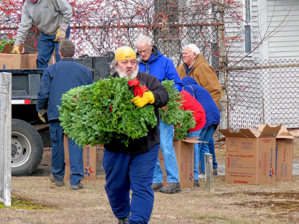 Matthew Wieczhalek-Seiler prepares to lay wreaths at veteran graves in Old North Cemetery in Concord Friday morning. Caitlin Andrews