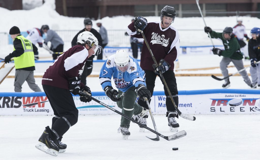 The Budmen and White Park Hockey Club battle it out on Saturday at the Black Ice Pond Hockey Tournament at White Park. The Budmen won 5-2. GEOFF FORESTER