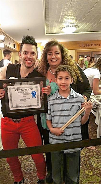 Justin Spencer of Recycled Percussion (left) was a past recipient of the Kindness Hero award from the Hearts for Kindness program. Courtesy of Brenda Perkins