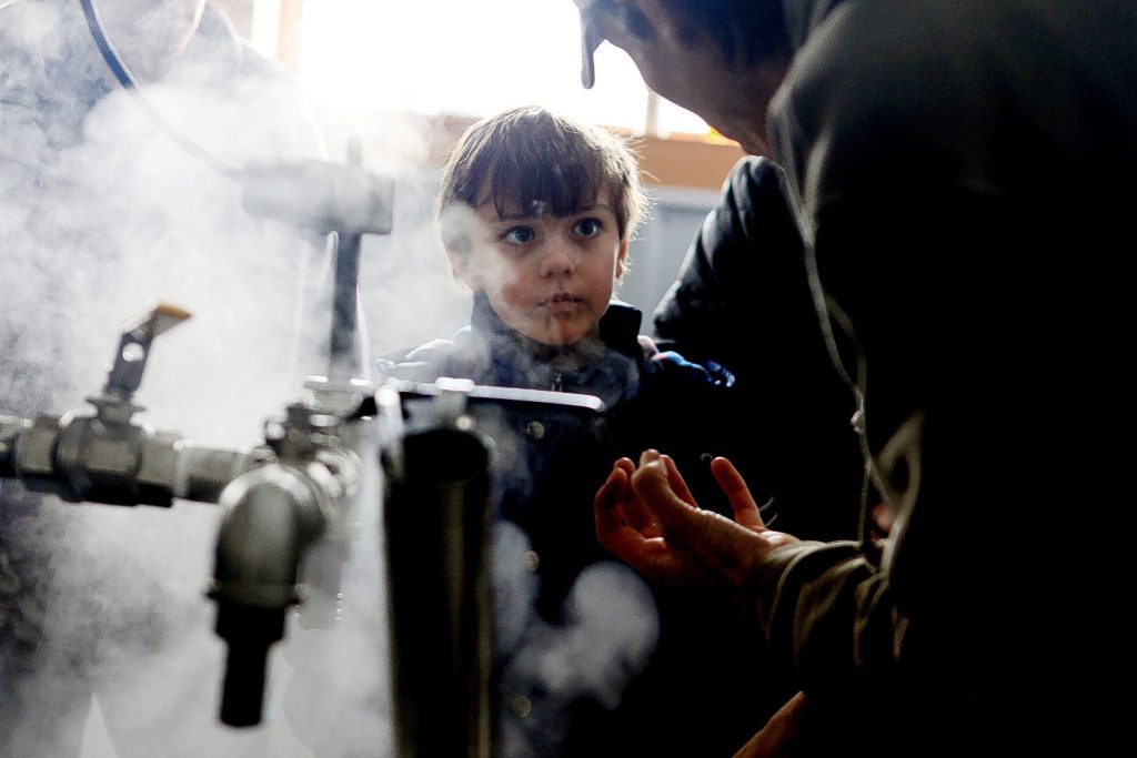 James Russell of Concord, 8, listens to Stefan Lillios explain how to make maple syrup in the boiling room at Maple Ridge Sugar House in Loudon on Saturday, March 22, 2014.  Visitors could see maple syrup being made, tour the farm, visit with a horse, a cow and pigs and taste maple treats.  (ARIANA van den AKKER / Monitor staff) James Russell, 8, of Concord, listens to Stefan Lillios explain how to make maple syrup in the boiling room at Maple Ridge Sugar House in Loudon yesterday. Visitors could watch maple syrup being produced, tour the farm, visit with a horse, a cow and pigs, and taste maple treats. Ariana van den Akker