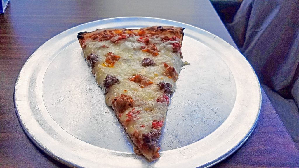 A slice of sausage and hamburger pizza from Vinnie's. JON BODELL / Insider staff